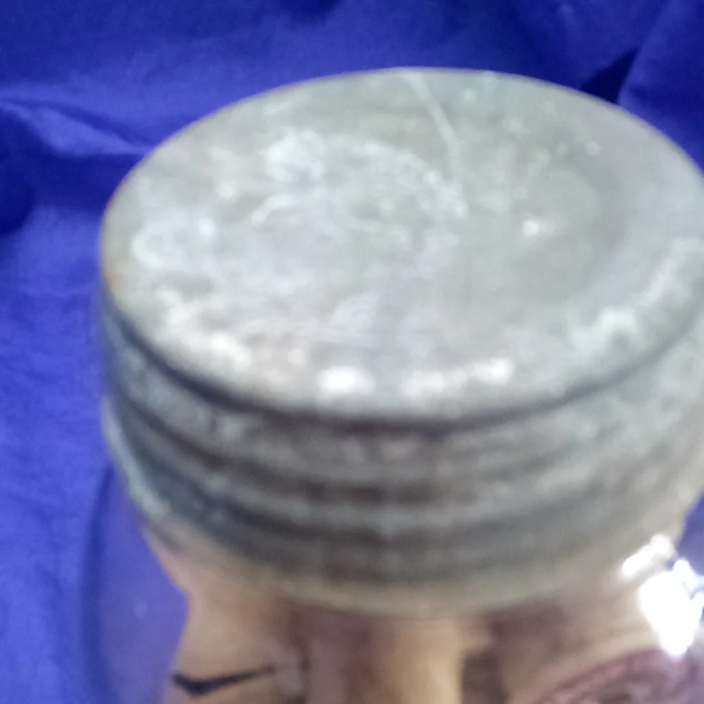 Vintage kerr Mason jar with 25 vintage wooden thread spools and a zinc l…